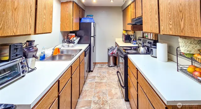 a kitchen with a sink a stove and cabinets