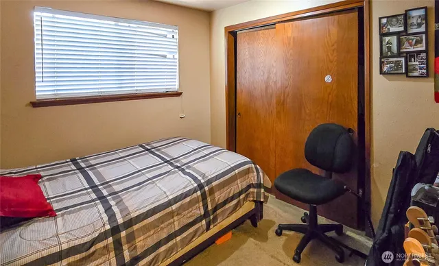 a bedroom with a bed and a chair