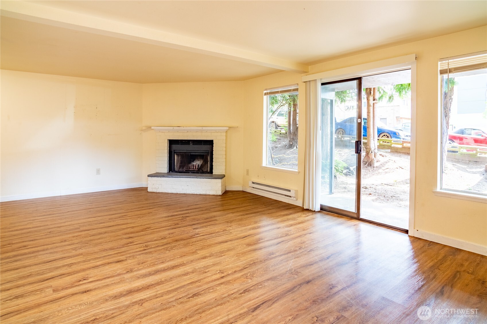 15609 8th Avenue Southwest Burien, WA 98166 - Photo 7 of 26 a view of empty room with wooden floor and fireplace