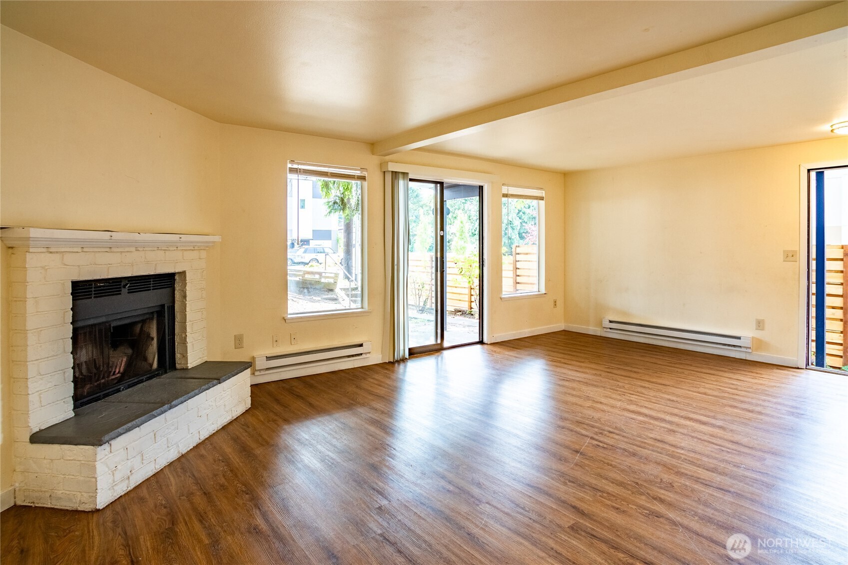 15609 8th Avenue Southwest Burien, WA 98166 - Photo 8 of 26 an empty room with wooden floor and fireplace