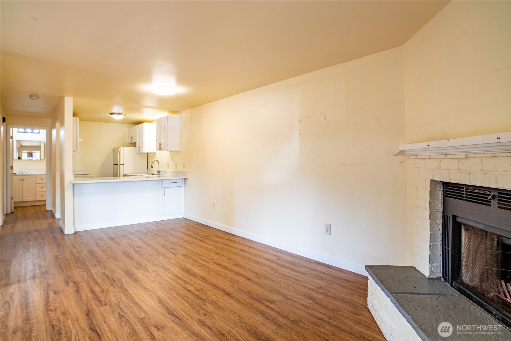 15609 8th Avenue Southwest Burien, WA 98166 - Photo 9 of 26 a view of kitchen and empty room with wooden floor