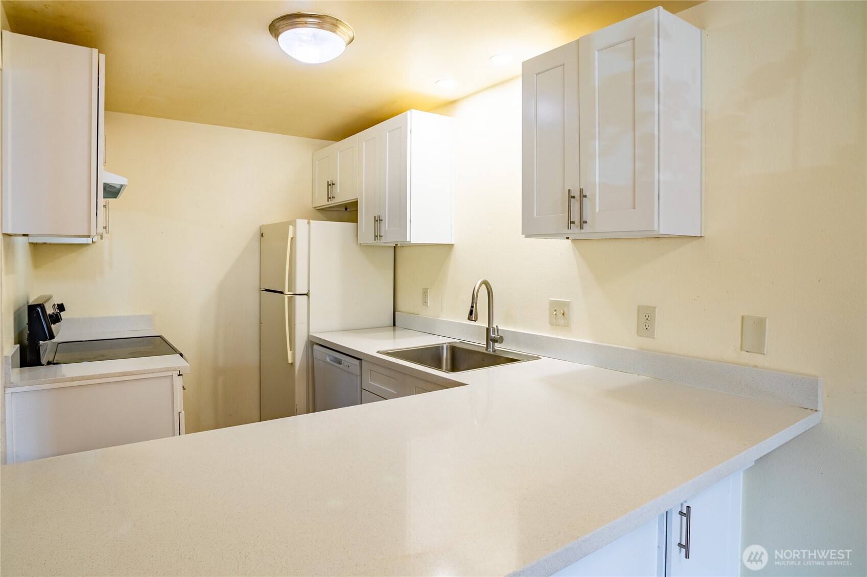 15609 8th Avenue Southwest Burien, WA 98166 - Photo 10 of 26 a kitchen with a sink a stove and refrigerator