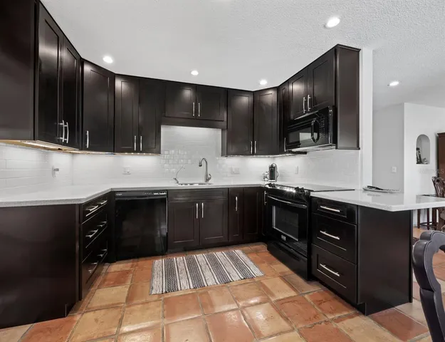 a kitchen with a sink stove and cabinets