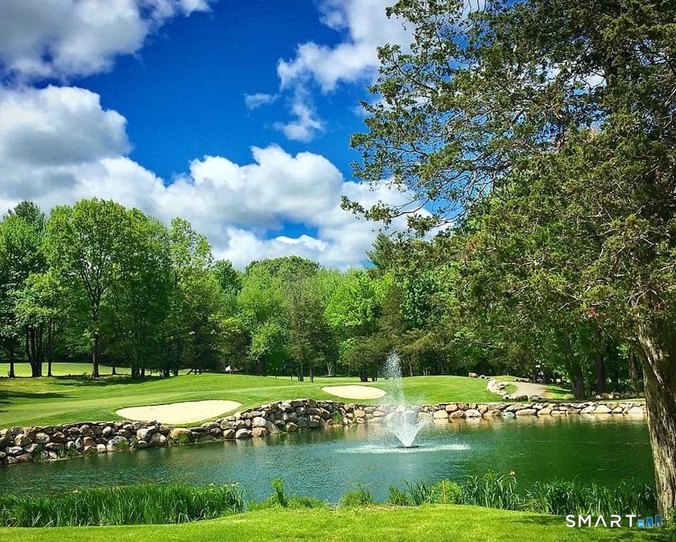 52 Shingle Mill Road Simsbury, CT 06092 - Photo 8 of 8 a view of a golf course with a lake