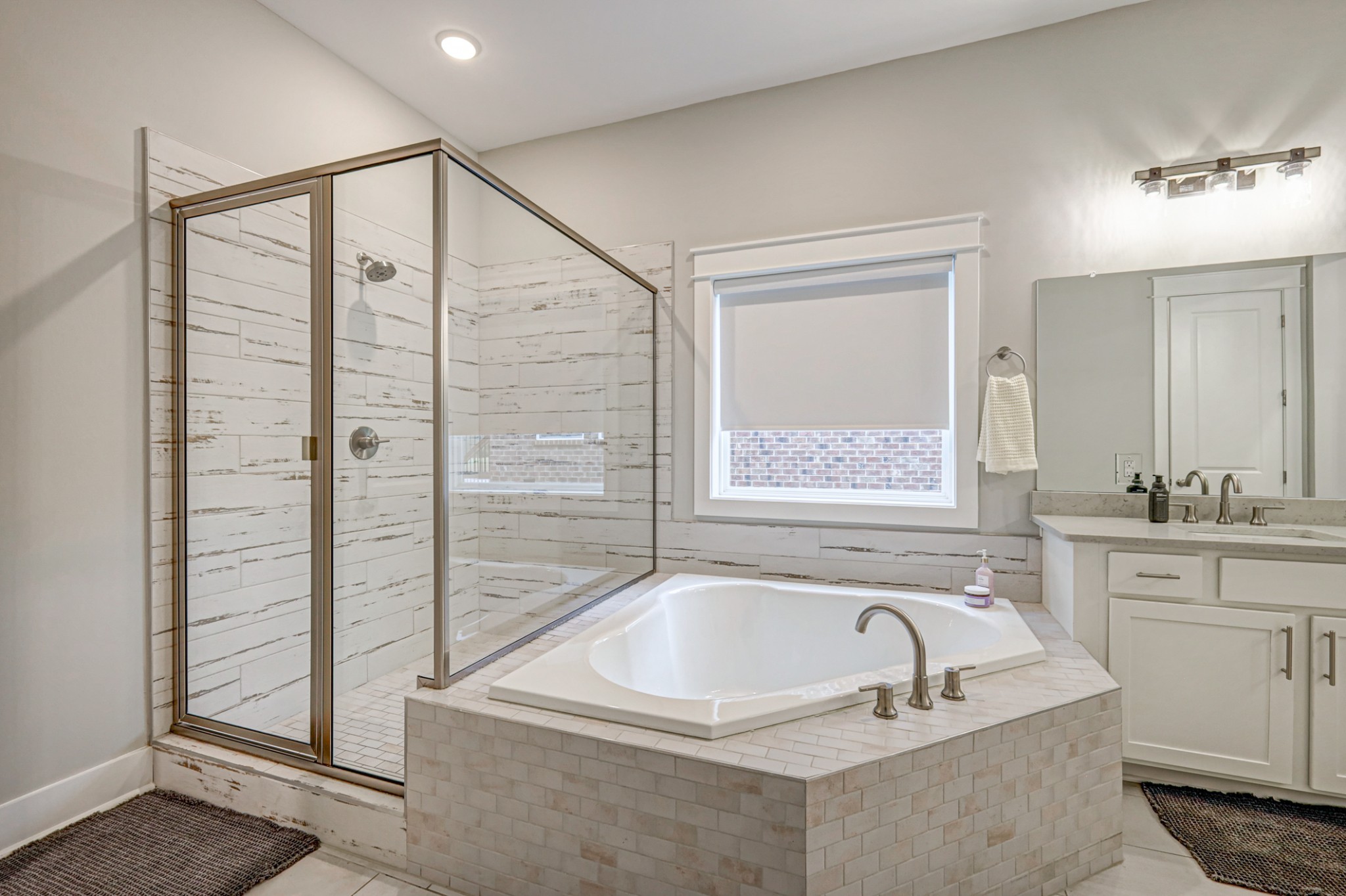 7748 Thayer Road Nolensville, TN 37135 - Photo 15 of 41 a bathroom with a granite countertop tub sink and mirror