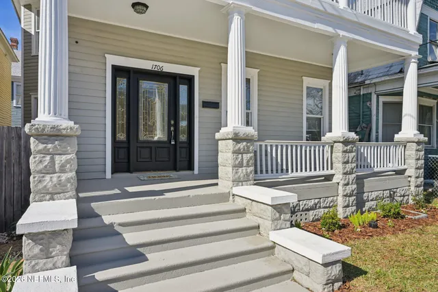 a view of a house with sitting area and wooden floor