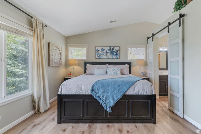 14883 Tooele Lane Draper, UT 84020 - Photo 26 of 49 Bedroom featuring vaulted ceilings, wood-finish flooring, and a large window