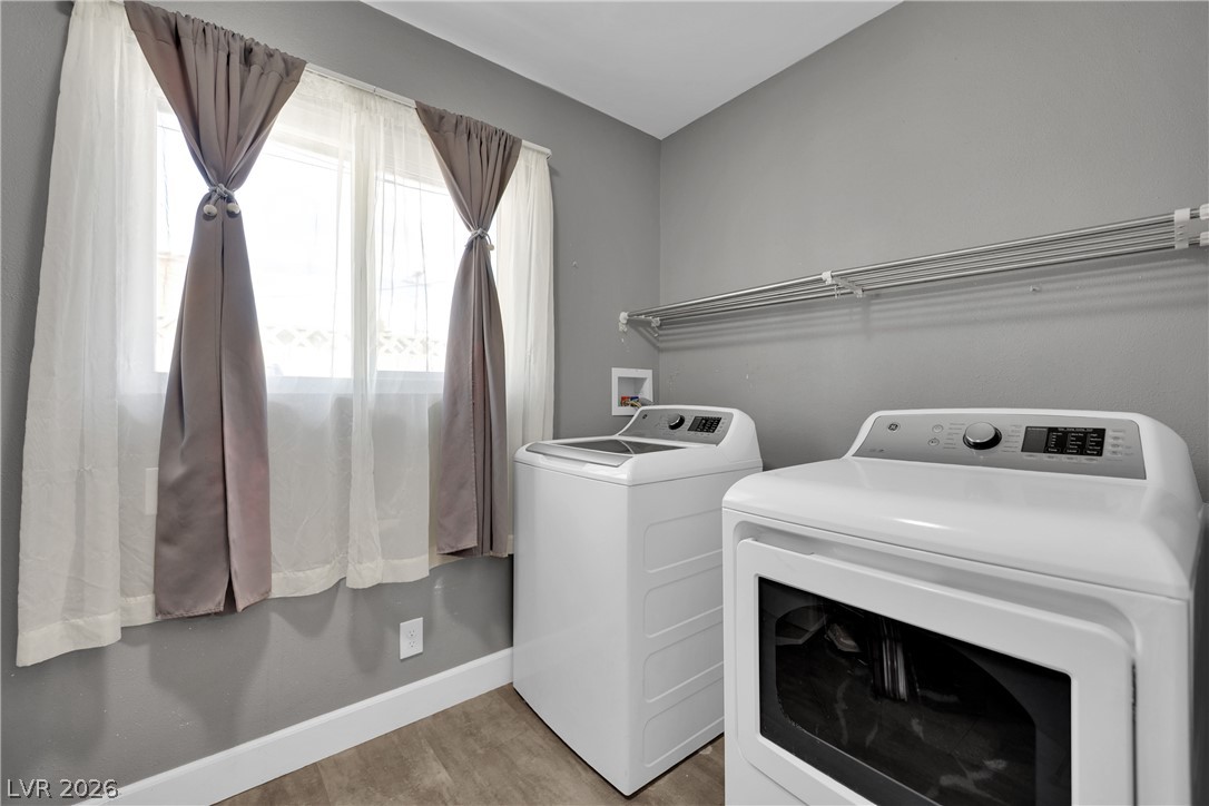 2221 Englestad Street North Las Vegas, NV 89030 - Photo 26 of 32 Functional utility space with dedicated appliances and ample drying racks, simplifying daily routines.