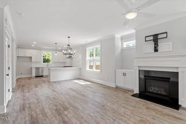 a view of a kitchen with a sink a fireplace and wooden floor
