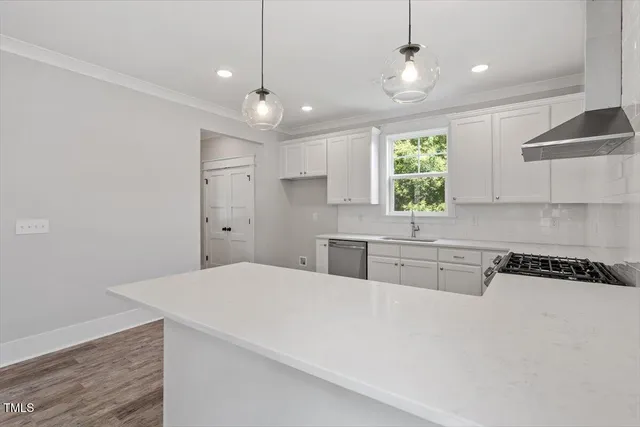a kitchen with granite countertop a sink cabinets and window