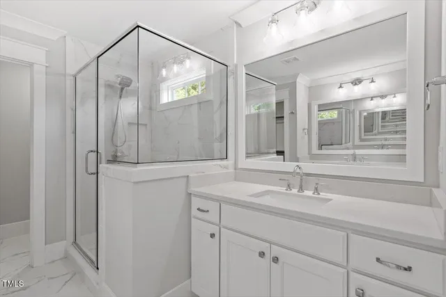 a bathroom with a shower sink and mirror