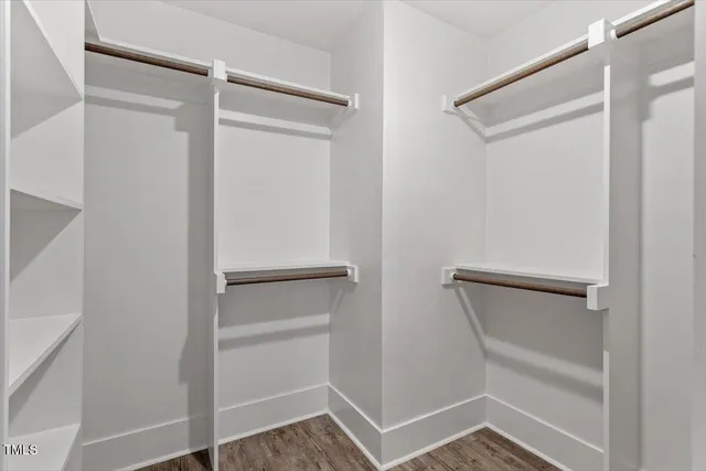 a view of walk in closet with empty racks