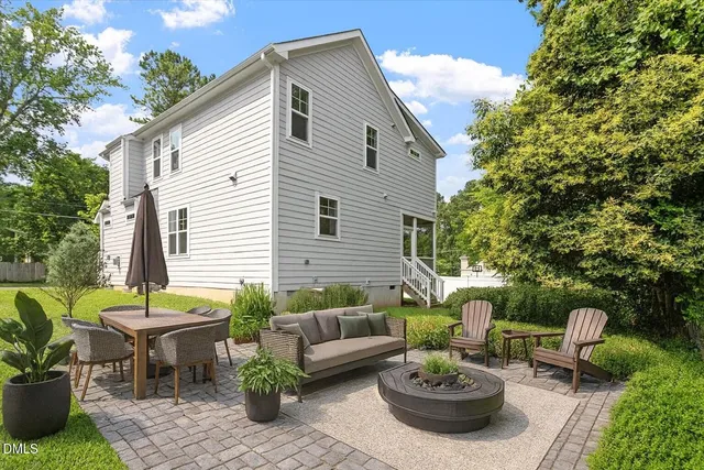 a view of a patio with couches table and chairs and potted plants