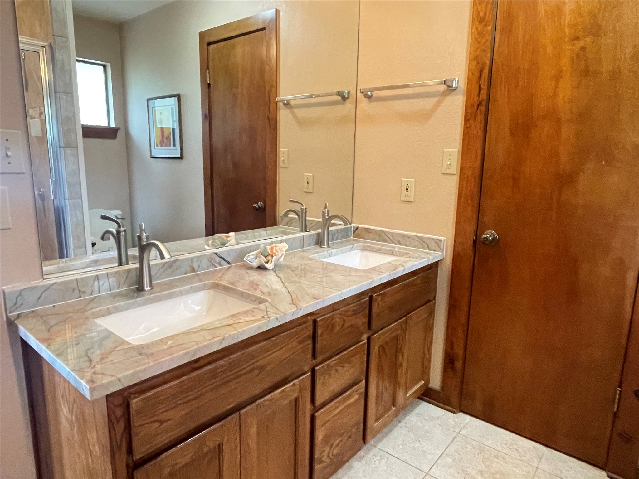 919 Little Ranches Road Wimberley, TX 78676 - Photo 9 of 13 Double vanity with elegant stone counters elevates daily routines.