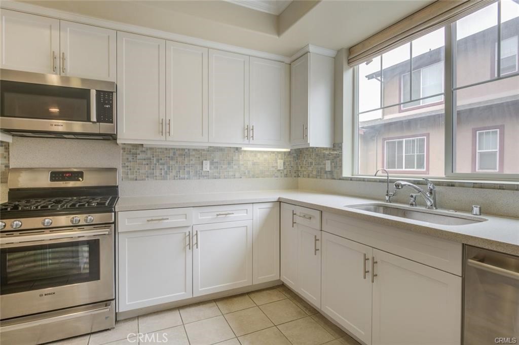 713 South Azusa Avenue, Unit D Azusa, CA 91702 - Photo 11 of 33 a kitchen with cabinets appliances and a sink