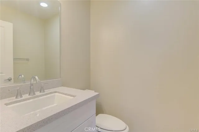 a bathroom with a sink a toilet and mirror