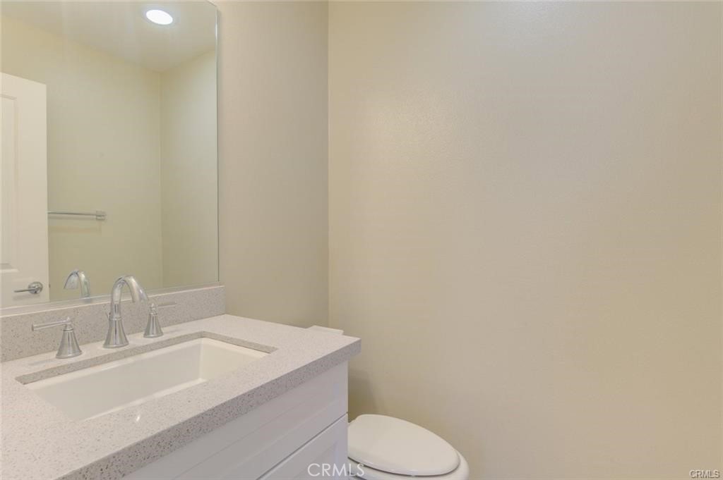 713 South Azusa Avenue, Unit D Azusa, CA 91702 - Photo 15 of 33 a bathroom with a sink a toilet and mirror