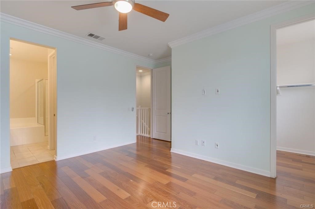713 South Azusa Avenue, Unit D Azusa, CA 91702 - Photo 18 of 33 an empty room with wooden floor chandelier fan and windows