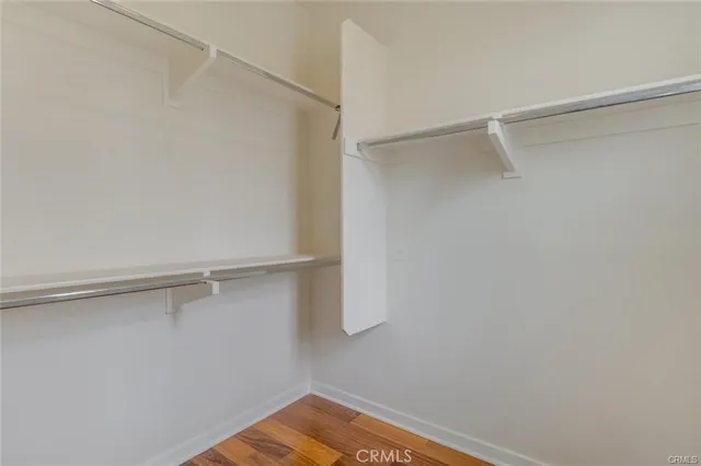 a view of walk in closet with empty racks