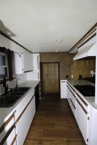 a kitchen with stainless steel appliances granite countertop a sink and a stove