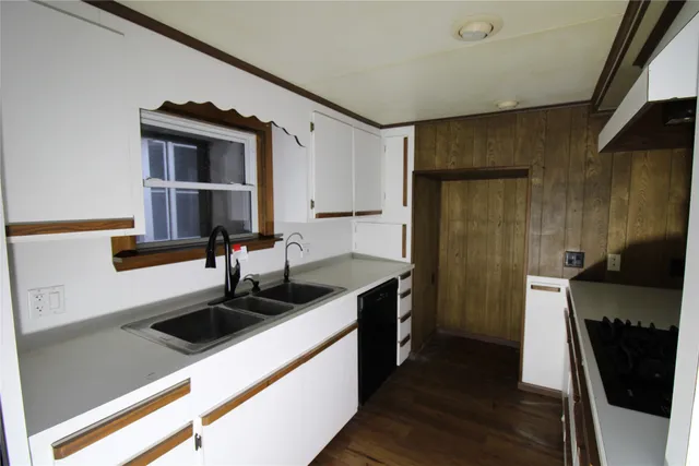 a kitchen with a sink and a refrigerator