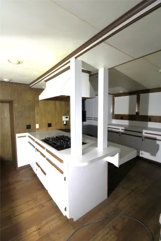 a large kitchen with stainless steel appliances and a large counter top