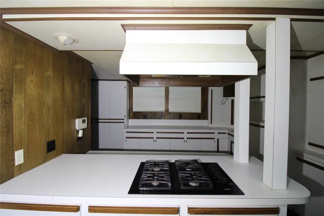 a kitchen with a stove and a refrigerator