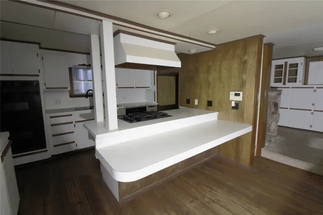 a kitchen with a refrigerator and a stove