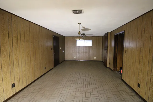 a view of a hallway with wooden shelves