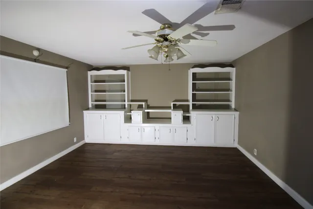 a view of a livingroom with furniture wooden floor and window