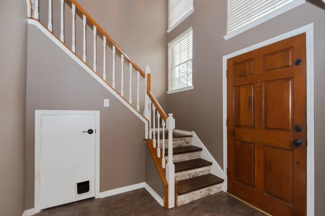 a view of entryway and hall with wooden floor
