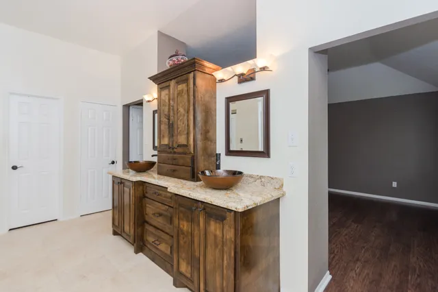 a bathroom with a granite countertop sink and a mirror