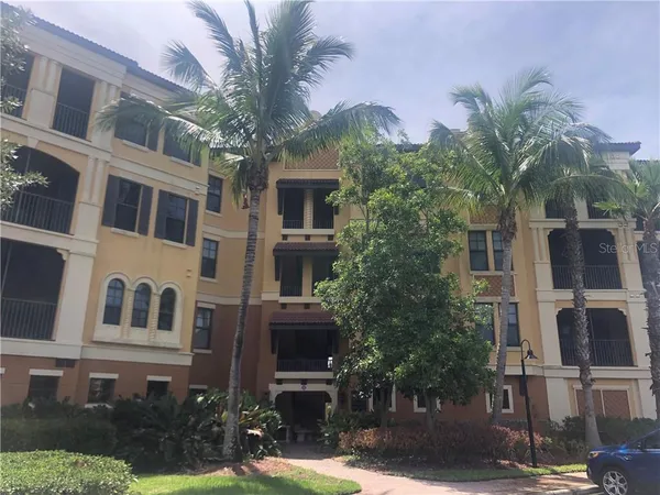 a front view of a multi story building with yard