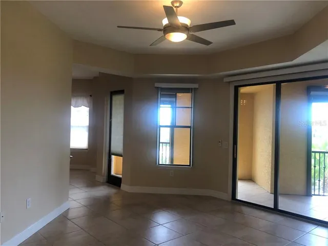 an empty room with closet and windows