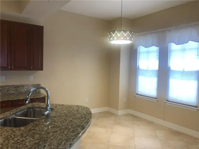 a kitchen with sink and cabinets