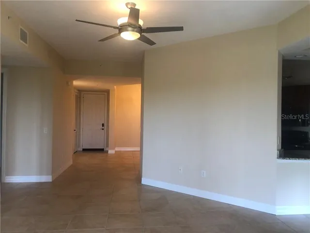 an empty room with a empty space and a ceiling fan