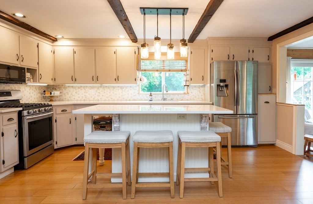 9 Parish Road Georgetown, MA 01833 - Photo 12 of 42 a kitchen with stainless steel appliances granite countertop a stove a sink and a refrigerator