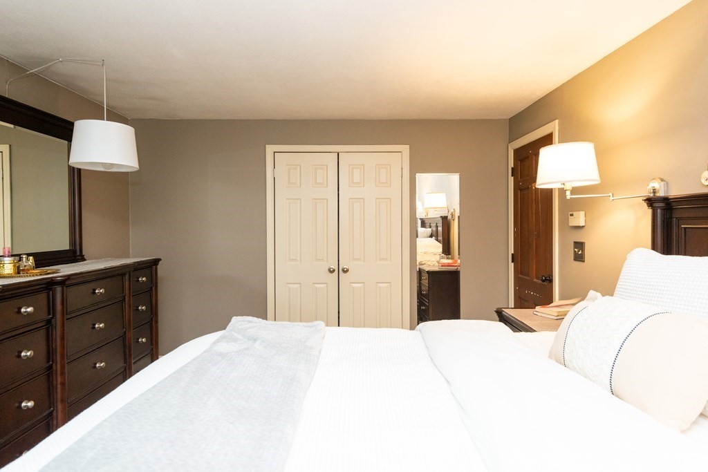 9 Parish Road Georgetown, MA 01833 - Photo 24 of 42 a bedroom with a bed and a flat screen tv in it