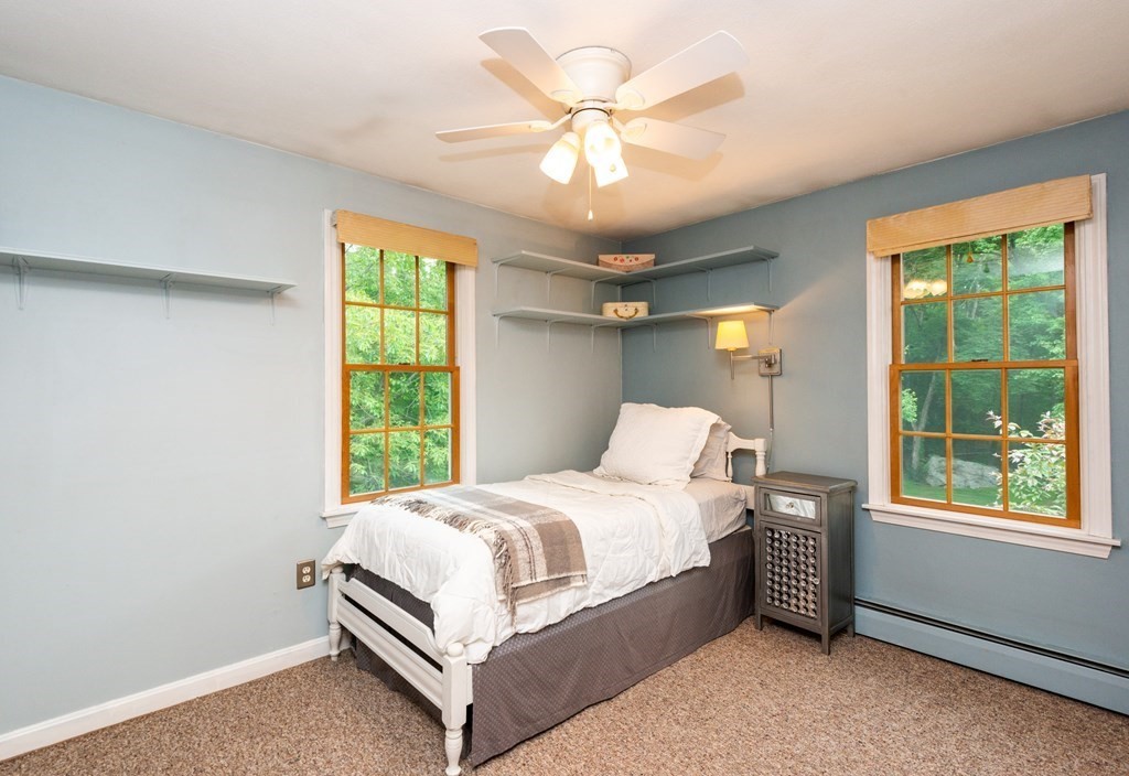 9 Parish Road Georgetown, MA 01833 - Photo 28 of 42 a bedroom with a bed chandelier and a large window