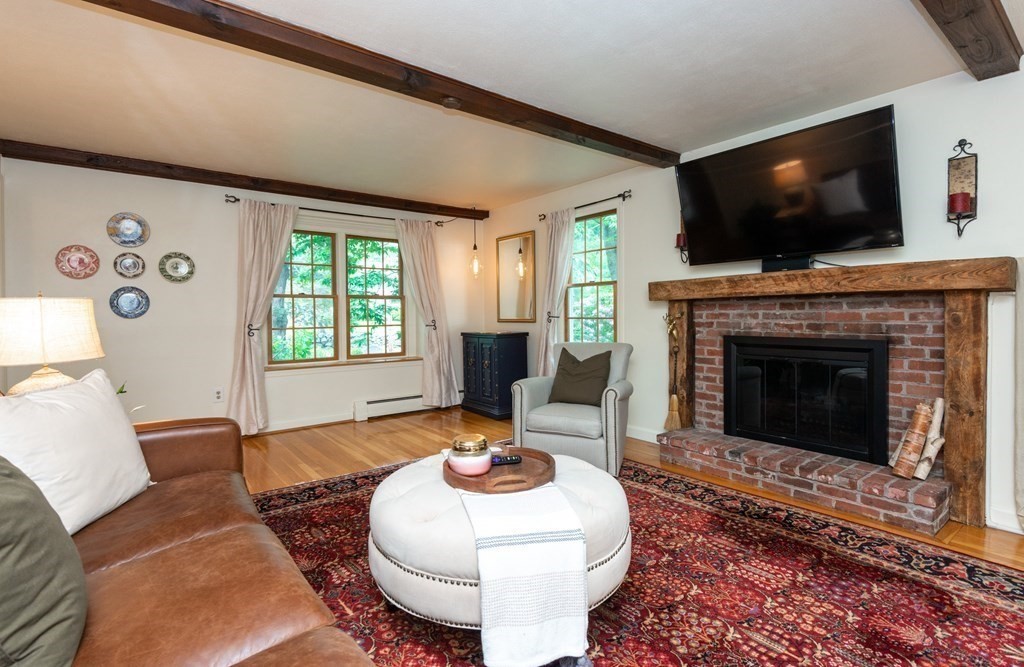 9 Parish Road Georgetown, MA 01833 - Photo 7 of 42 a living room with furniture a flat screen tv and a fireplace