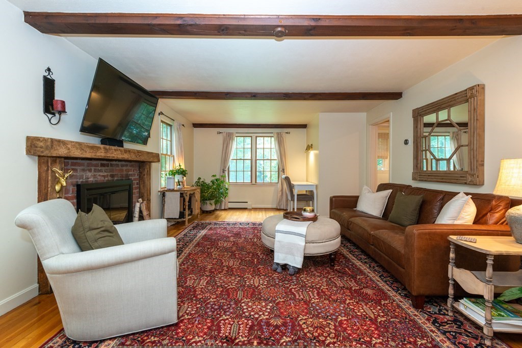 9 Parish Road Georgetown, MA 01833 - Photo 8 of 42 a living room with furniture a fireplace and a flat screen tv