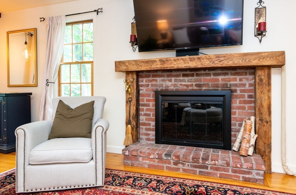 9 Parish Road Georgetown, MA 01833 - Photo 10 of 42 a living room with furniture and a fireplace