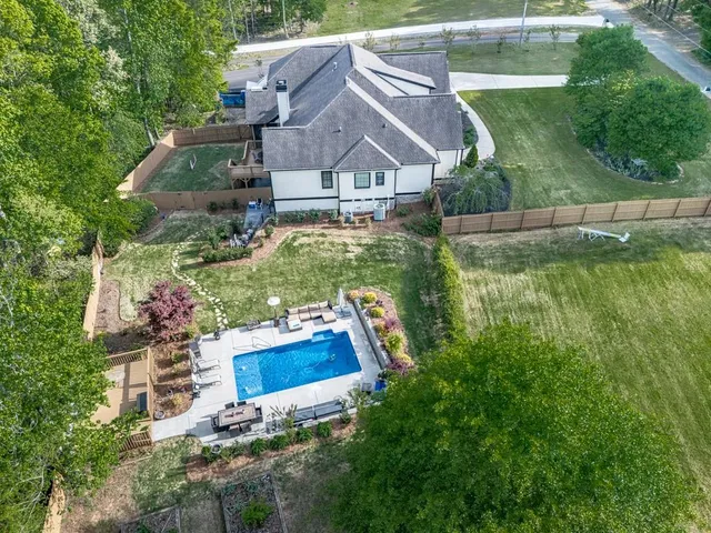a kitchen with stainless steel appliances granite countertop a table chairs stove microwave and cabinets