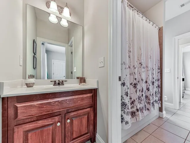 a bathroom with a sink a toilet and mirror