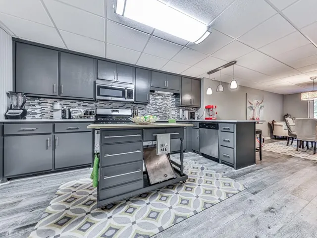 a front view of a house with a garden and trees