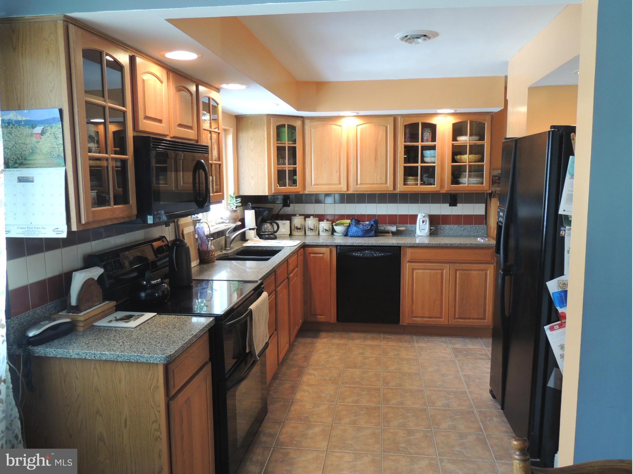 11823 Houck Road Union Bridge, MD 21791 - Photo 4 of 30 a kitchen with a sink stove top oven and refrigerator