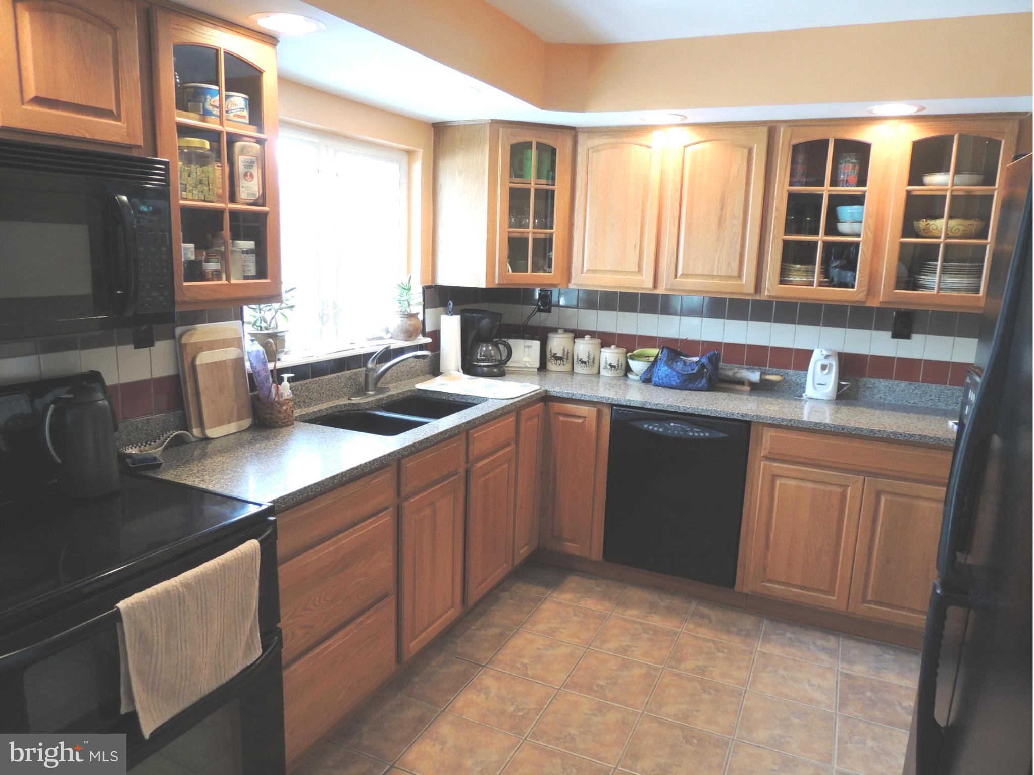 11823 Houck Road Union Bridge, MD 21791 - Photo 5 of 30 a kitchen with a sink stove and cabinets