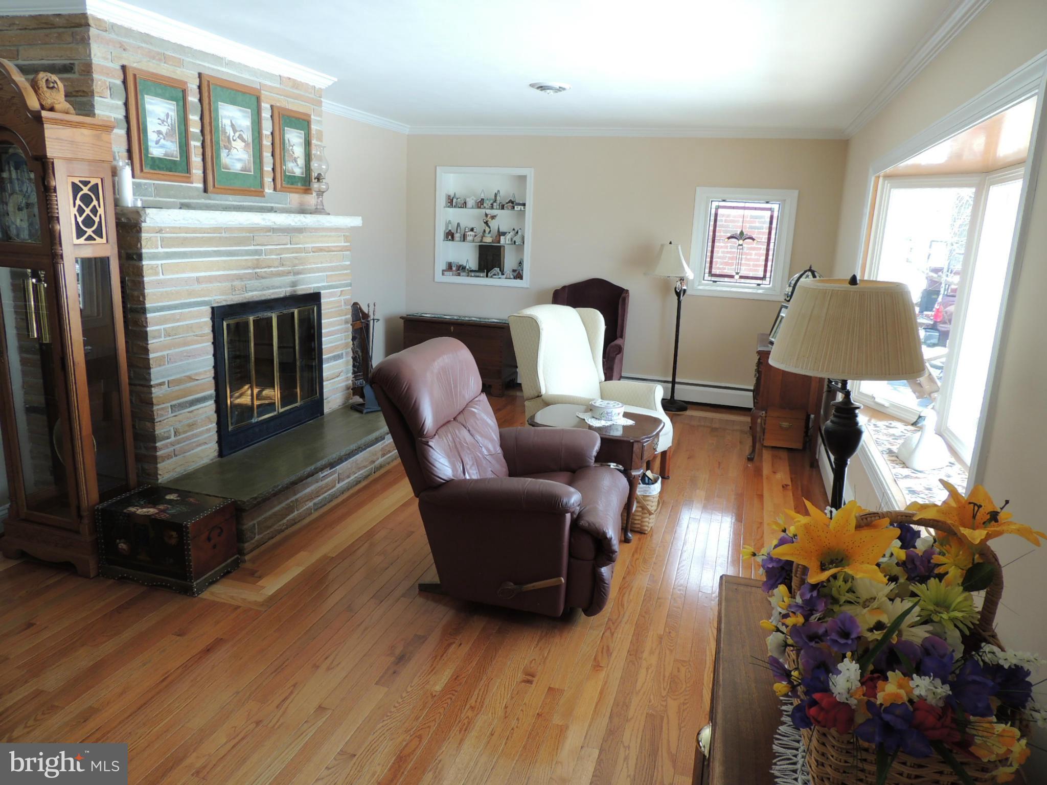 11823 Houck Road Union Bridge, MD 21791 - Photo 7 of 30 a living room with furniture a flat screen tv and a fireplace