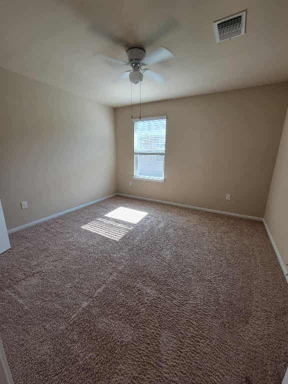 213 Camellia Drive Hutto, TX 78634 - Photo 15 of 27 an empty room with a ceiling fan and window