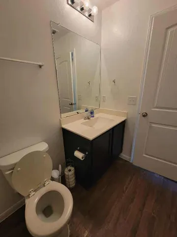 a bathroom with a sink a toilet and mirror